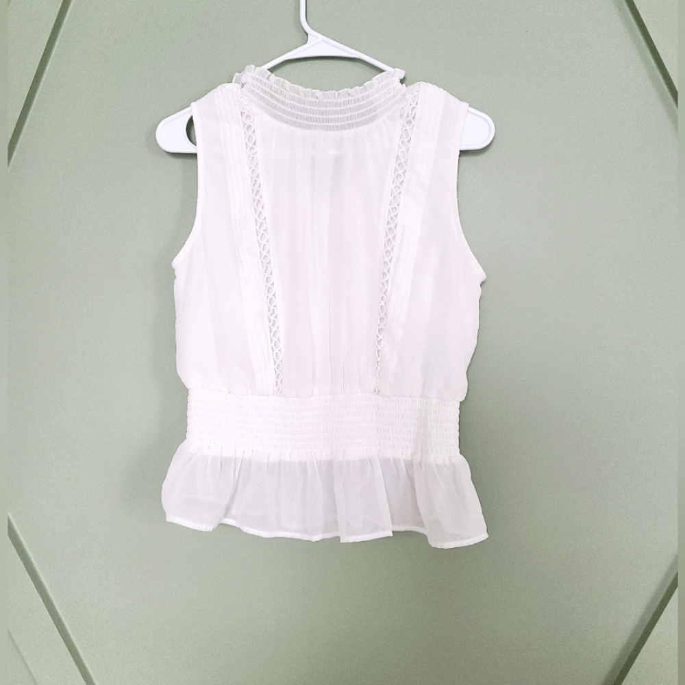 White sleeveless ruffle top